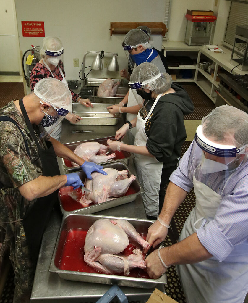 Volunteers prepare turkeys to be fried